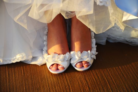 detail shot of bride's white floral shoes