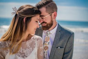 bride groom touching foreheads at the beach in florida, beach permit for wedding, beach wedding