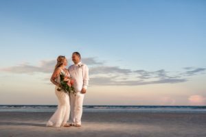 a husband and wife who just got married on the beach in jacksonville florida, wedding planner, best beach wedding venue