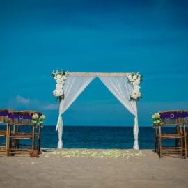 beach wedding ceremony with arbor