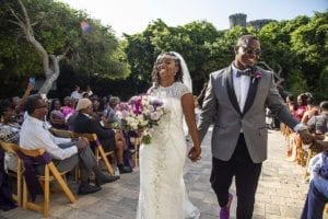 a black couple walking back down the aisle after getting married, how to write wedding vows, wedding vows