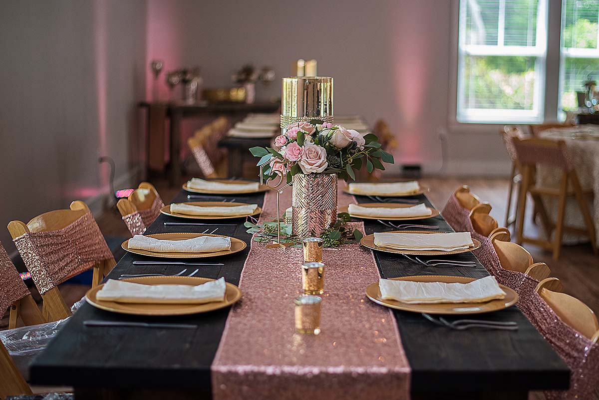 Wedding reception table decorated with pink and gold details