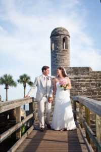 a newly married coyple posing while looking at each other in St. Augustine Fort Weddings, beach wedding, winter beach wedding