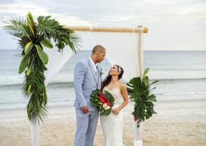 bride and groom standing on the beach in front of a  tropical altar, how to write wedding vows, wedding vows