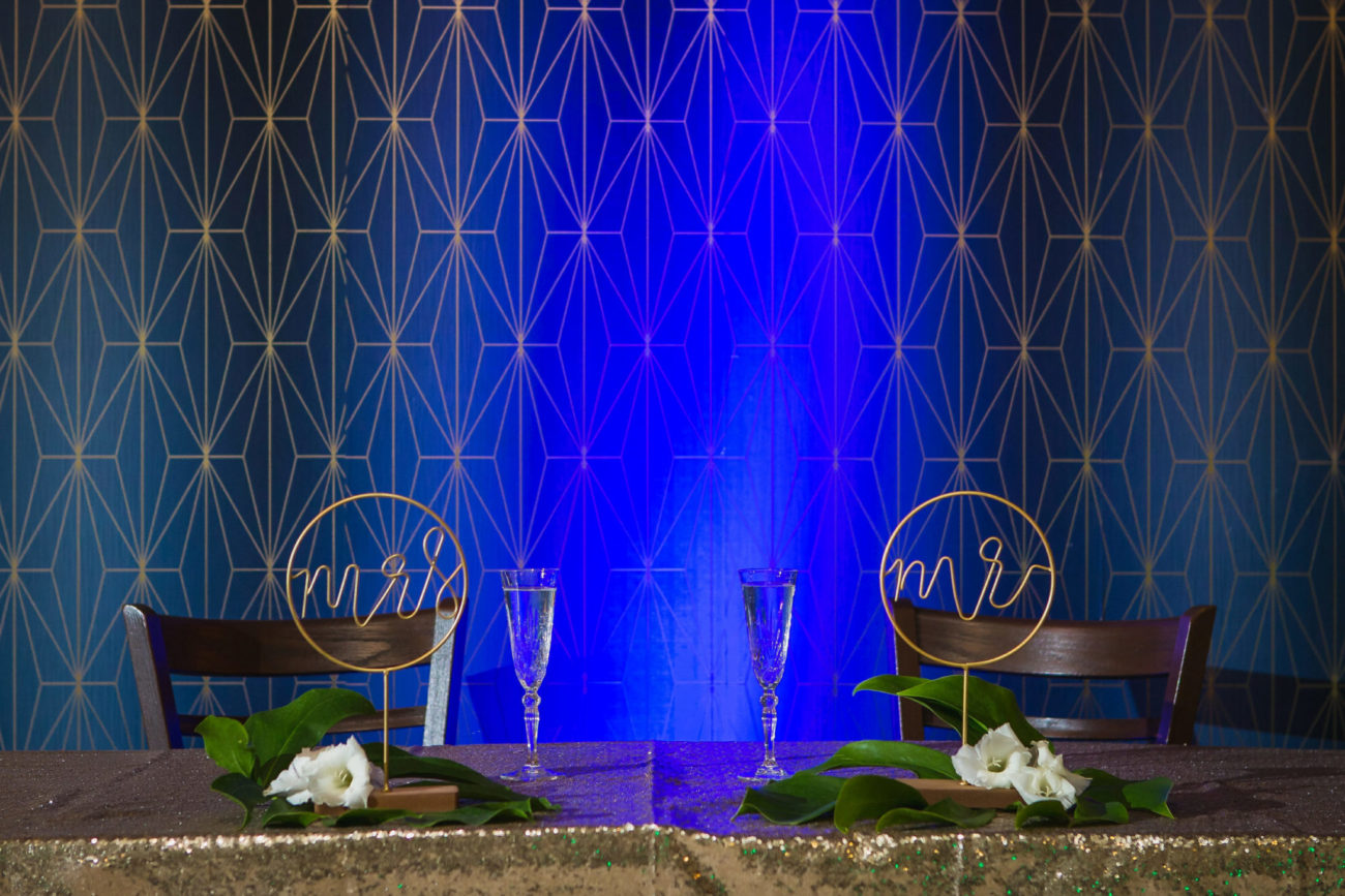 decorated Sweetheart table in front blue abstract wall