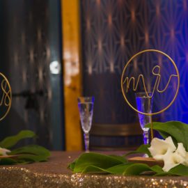 decorated Sweetheart table in front blue abstract wall