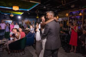 bride and groom dancing at their wedding, beach wedding, how to include your child in your wedding ceremony