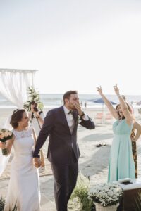 a bride and groom walking down the aisle after saying their vows on the beach, beach wedding, st augustine wedding