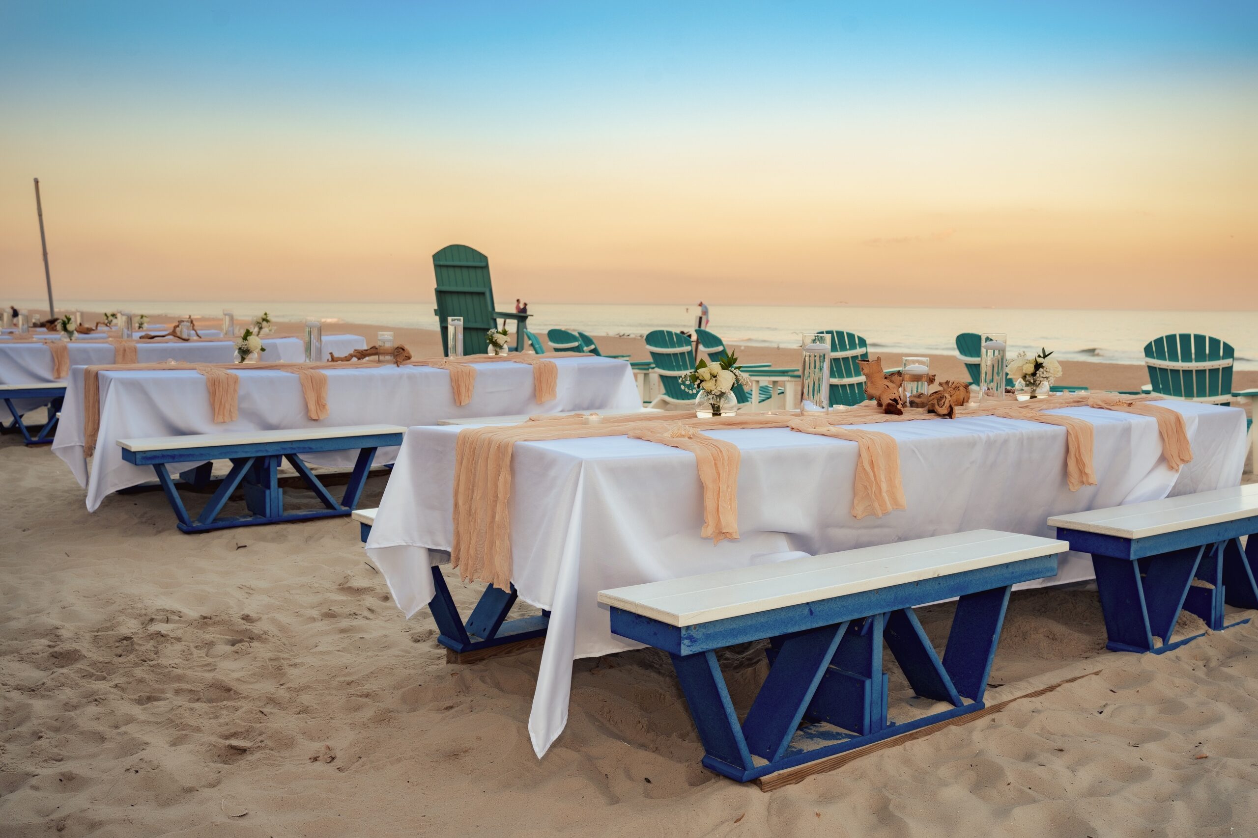 a reception set up on the beach for a beach wedding that used a beach wedding timeline guide